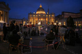 Members of the media wait outside St Peter's Basilica, following the death of the pontiff, on the day of the translation of Pope Francis' coffin, where it was transported inside the Basilica, as seen from Rome, Italy, 23 April 2025
